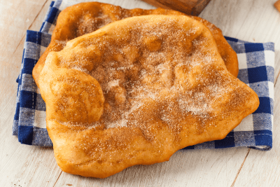 How to Make the Best Elephant Ear Recipe at Home: An Easy Guide! 41 Golden, freshly fried dough sprinkled with powdered sugar, perfect for recreating a classic fairground dessert at home.