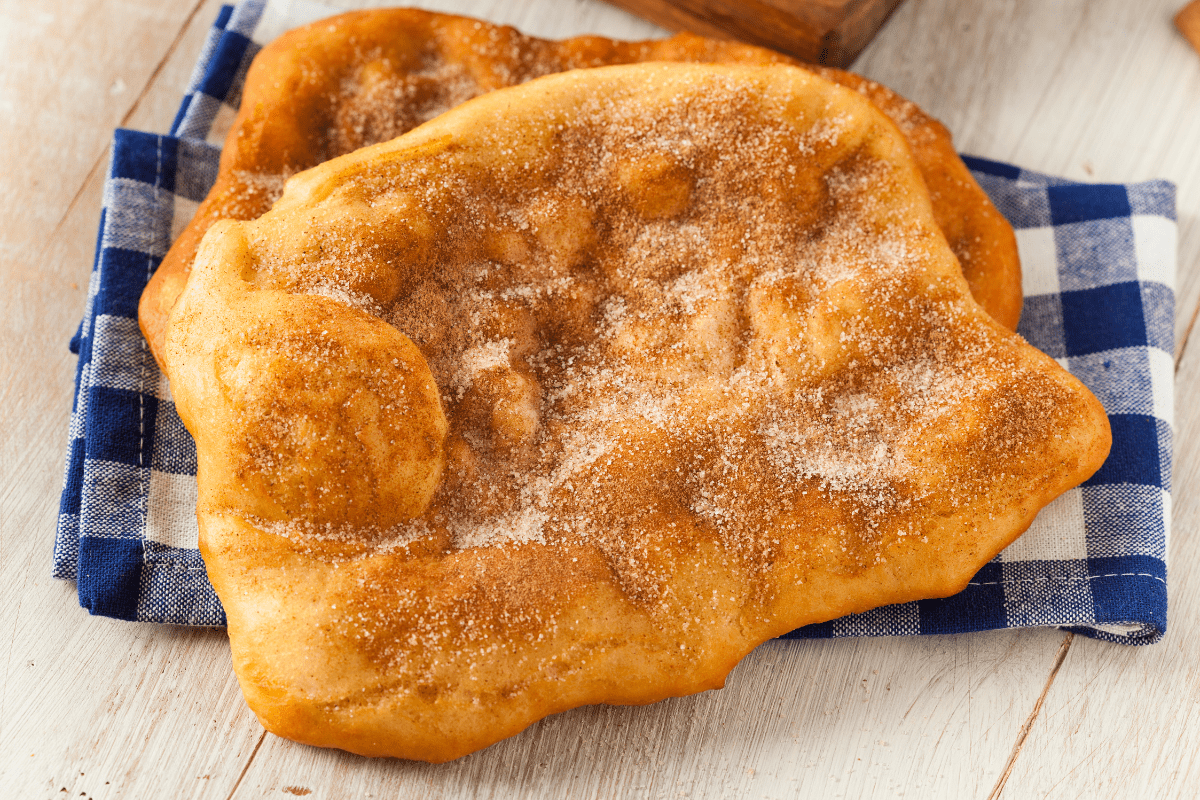 How to Make the Best Elephant Ear Recipe at Home: An Easy Guide! 15 Golden, freshly fried dough sprinkled with powdered sugar, perfect for recreating a classic fairground dessert at home.