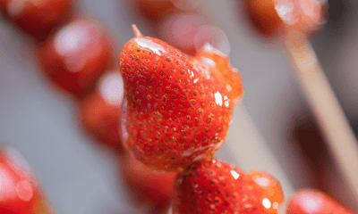 Tanghulu Recipe: How to Make Chinese Candied Fruit – A Classic Chinese Street Treat 84 Close-up of glossy Tanghulu, a popular asian.candy, featuring fresh strawberries coated in a crispy sugar shell, making it a delicious candied fruit treat.