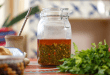 Chimichurri Sauce: Learn How to Make the Authentic Chimichurri Sauce Recipe from Argentina 19 Close-up of freshly made chimichurri sauce in a glass jar, showcasing its vibrant green color and texture.